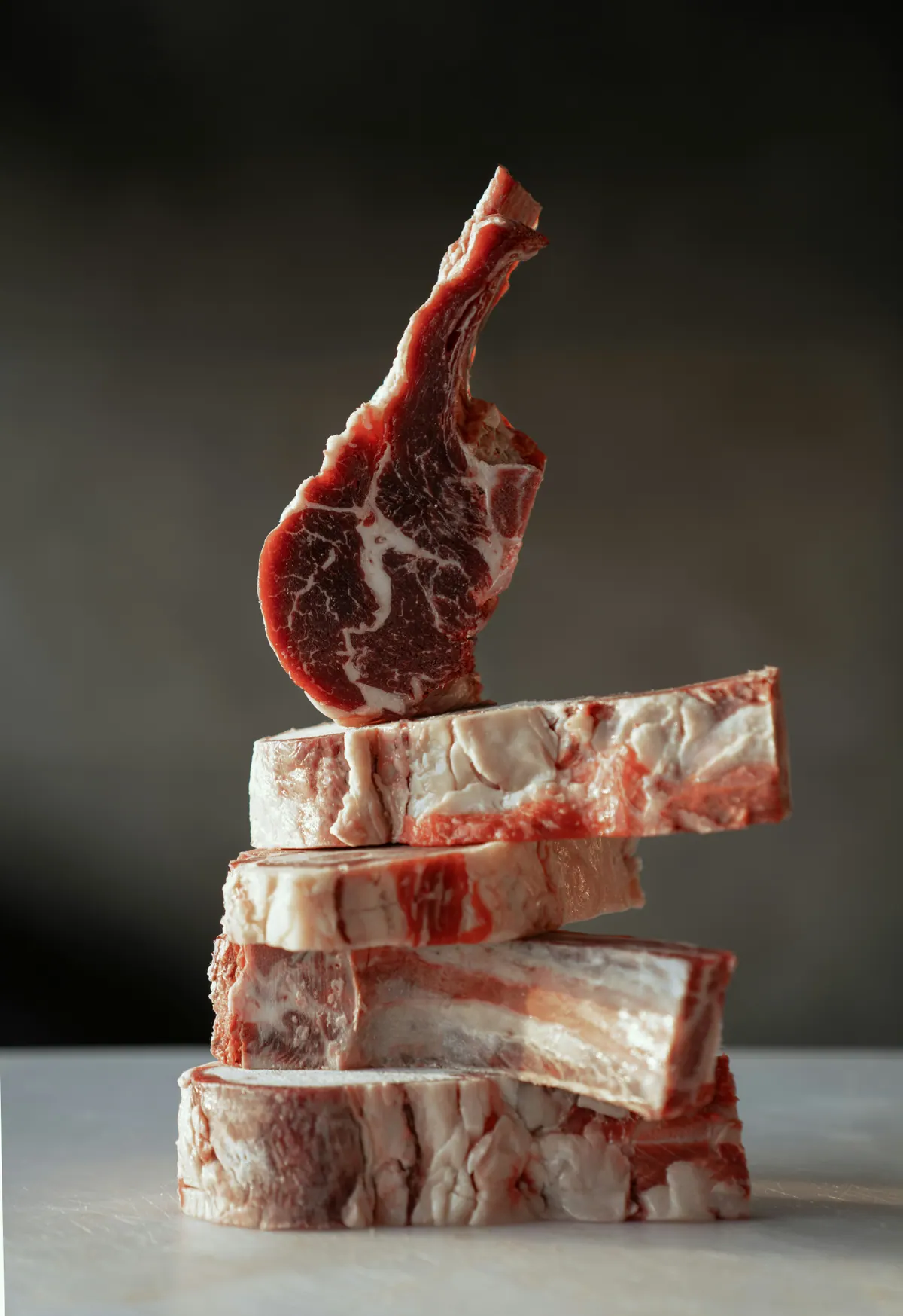Raw beef cuts arranged against a dark background