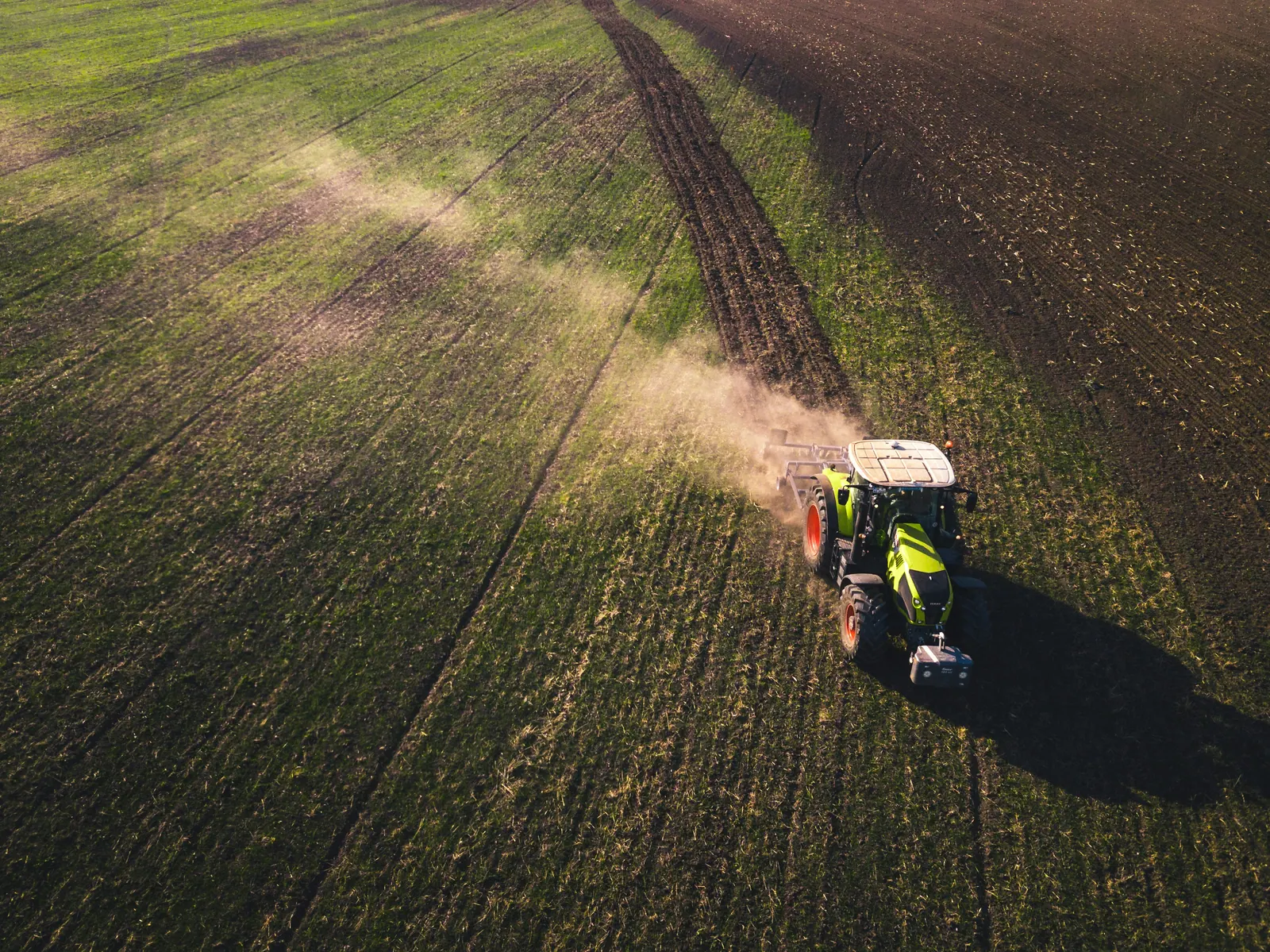 Tractor working across cultivated fields